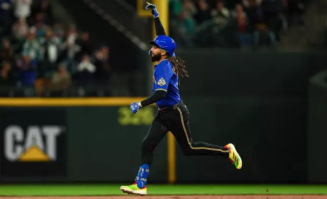 Seattle Mariners' J.P. Crawford gestures as he rounds the bases after hitting a one-run home run against the Arizona Diamondbacks during the first inning of a baseball game Friday, May 29, 2026, in Seattle. (AP Photo/Caean Couto)