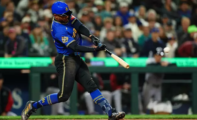 Seattle Mariners' Julio Rodríguez hits a two-run home run against the Arizona Diamondbacks during the third inning of a baseball game Friday, May 29, 2026, in Seattle. (AP Photo/Caean Couto)