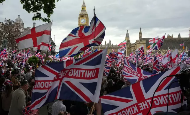 Protesters wave flags during the far right Unite the Kingdom march in London, Saturday, May 16, 2026.(AP Photo/Kirsty Wigglesworth)
