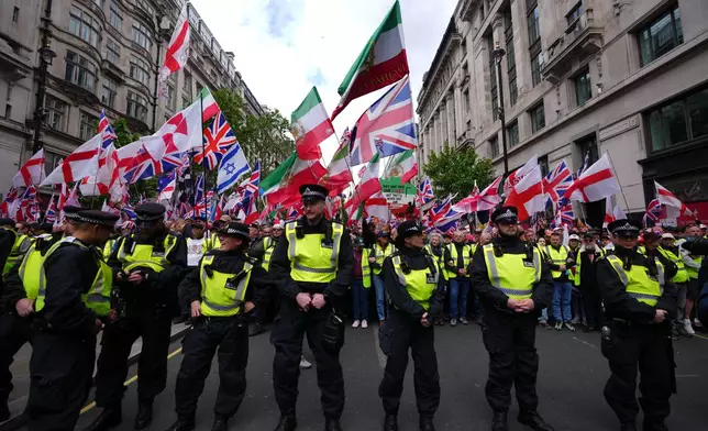 Police forces stand in front of the far right Unite the Kingdom march in London, Saturday, May 16, 2026.(AP Photo/Kirsty Wigglesworth)