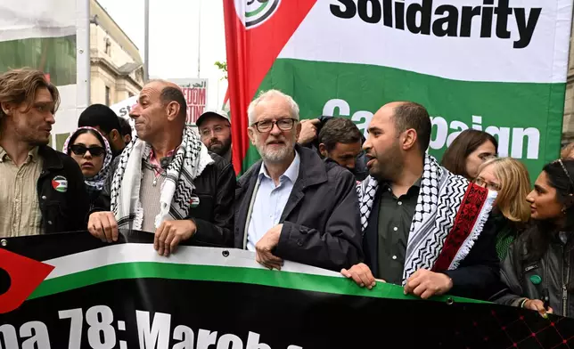 Member of Parliament Jeremy Corbin holds a banner during a Pro-Palestine march in London, Saturday, May 16, 2026.(AP Photo/Thomas Krych)