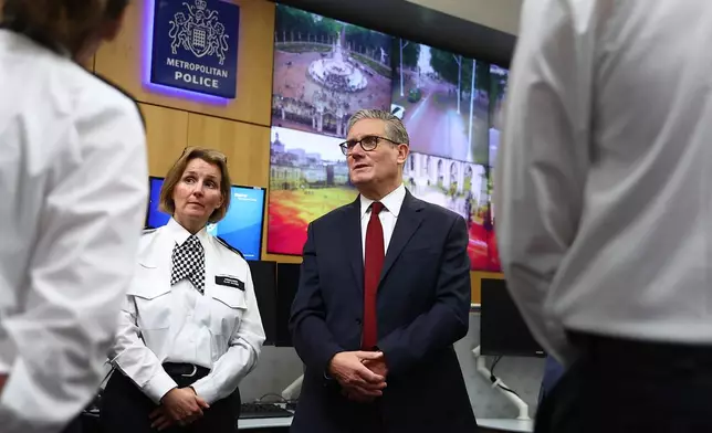 Britain's Prime Minister Keir Starmer and Commander Clair Haynes meet with police officers to discuss operational planning ahead of this weekend's protests in London, Friday, May 15, 2026. (Peter Nicholls/Pool Photo via AP)