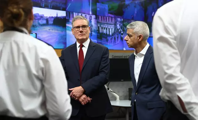 Britain's Prime Minister Keir Starmer and Mayor of London Sadiq Khan, right, meet with police officers to discuss operational planning ahead of this weekend's protests in London, Friday, May 15, 2026. (Peter Nicholls/Pool Photo via AP)