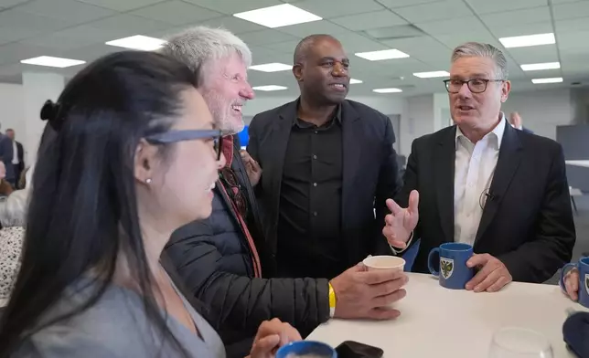 British Prime Minister Sir Keir Starmer and Foreign Secretary David Lammy meeting Labour Party members during a visit to AFC Wimbledon in south London, Saturday May 9, 2026. (Maja Smiejkowska/PA via AP)