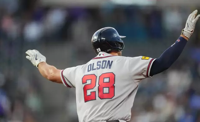 Atlanta Braves' Matt Olson gestures to the bullpen as he circles the bases after hitting a solo home run off Colorado Rockies starting pitcher Jose Quintana in the fourth inning of a baseball game Friday, May 1, 2026, in Denver. (AP Photo/David Zalubowski)