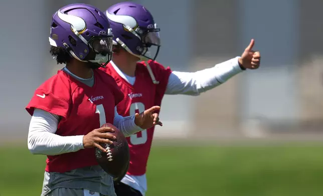 Minnesota Vikings quarterbacks Kyler Murray, front, and J.J. McCarthy (9) train during an NFL football practice Wednesday, May 27, 2026, in Eagan, Minn. (AP Photo/Abbie Parr)
