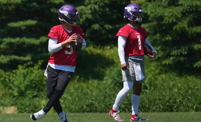 Minnesota Vikings quarterbacks J.J. McCarthy (9), and Kyler Murray (1) train during an NFL football practice Wednesday, May 27, 2026, in Eagan, Minn. (AP Photo/Abbie Parr)