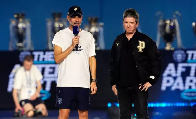 Manchester City manager Pep Guardiola, left, and singer Noel Gallagher, right, during a stage event following a parade to celebrate the achievements of the Manchester City men's and women's teams this season in Manchester, England, Monday, May 25, 2026. (Nick Potts/PA via AP)