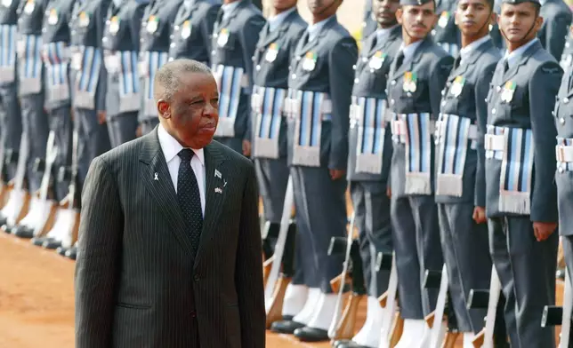 FILE - President of the Republic of Botswana Festus Mogae inspects the ceremonial guard of honor at the Rashtrapati Bhawan (Presidential Palace), in New Delhi, Dec. 8, 2006. (AP Photo/ Mustafa Quraishi, File)