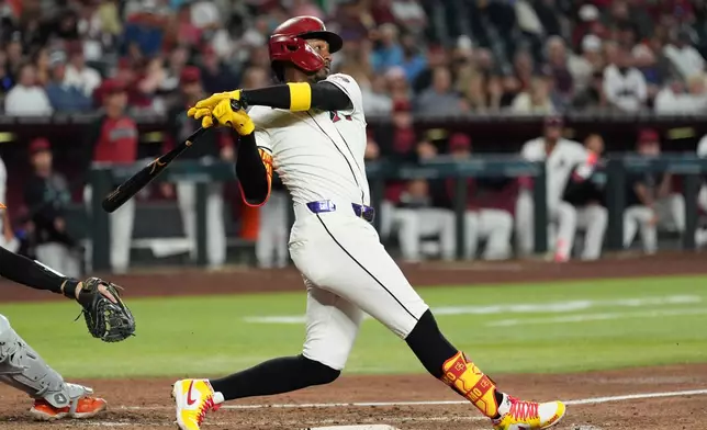 Arizona Diamondbacks' Geraldo Perdomo watches the flight of his two-run double against the San Francisco Giants during the fifth inning of a baseball game, Wednesday, May 20, 2026, in Phoenix. (AP Photo/Ross D. Franklin)