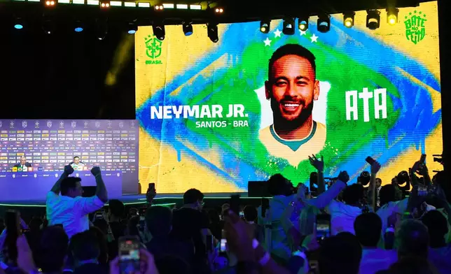 A screen displays an image of Neymar after coach Carlo Ancelotti, left, included him in Brazil's squad for the 2026 FIFA World Cup in Rio de Janeiro, Monday, May 18, 2026. (AP Photo/Silvia Izquierdo)