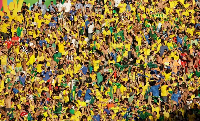 FILE -Brazil fans celebrate the World Cup round of 16 soccer match between Brazil and Chile at the Mineirao Stadium in Belo Horizonte, Brazil, June 28, 2014. (AP Photo/Hassan Ammar, File)