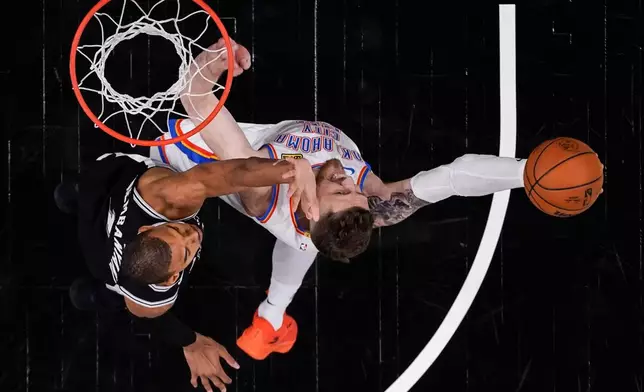Oklahoma City Thunder center Isaiah Hartenstein (55) shoots against San Antonio Spurs forward Victor Wembanyama (1) in the second half of Game 6 in the Western Conference finals NBA basketball playoffs series, Thursday, May 28, 2026, in San Antonio. (AP Photo/David J. Phillip)