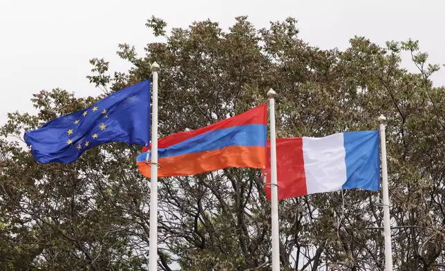 From left, the EU, Armenian and French flags flap in the wind outside the Presidential Palace during the EU-Armenia summit in Yerevan, Armenia, Tuesday, May 5, 2026. (AP Photo/Anthony Pizzoferrato)