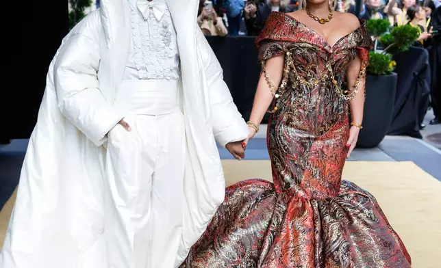 Jon Batiste, left, and Suleika Jaouad depart The Carlyle Hotel prior to attending The Metropolitan Museum of Art's Costume Institute benefit gala celebrating the opening of the "Costume Art" exhibition on Monday, May 4, 2026, in New York. (Photo by Charles Sykes/Invision/AP)
