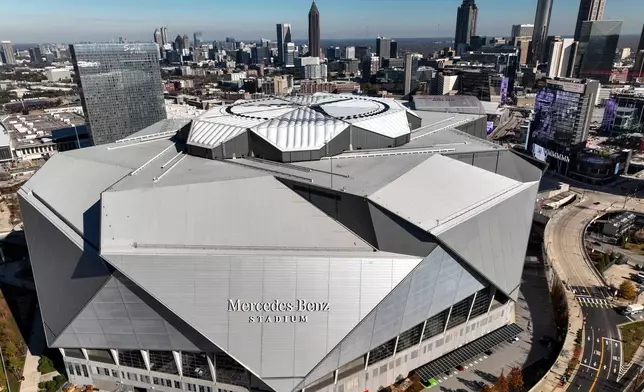 FILE - The Mercedes Benz stadium and Atlanta skyline is seen, Friday, Dec. 12, 2025, in Atlanta. (AP Photo/Mike Stewart,File)