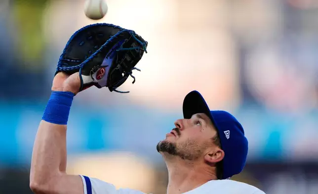 Kansas City Royals first baseman Vinnie Pasquantino catches a fly ball for the out on Cleveland Guardians' Rhys Hoskins during the third inning of a baseball game Wednesday, May 6, 2026, in Kansas City, Mo. (AP Photo/Charlie Riedel)