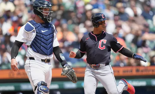 Cleveland Guardians' Brayan Rocchio, right, scores as Detroit Tigers catcher Dillon Dingler, left, looks on during the third inning of a baseball game Thursday, May 21, 2026, in Detroit. (AP Photo/Paul Sancya)