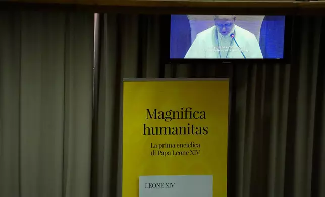 Pope Leo XIV, left, attends the presentation of his first encyclical, "Magnifica humanitas: On Safeguarding the Human Person in the Time of Artificial Intelligence," at the Vatican, Monday, May 25, 2026. (AP Photo/Alessandra Tarantino)