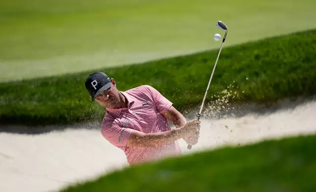 Gary Woodland hits out of the seventh green bunker during a PGA Championship golf tournament practice round at Aronimink Golf Club, Tuesday, May 12, 2026, in Newtown Square, PA. (AP Photo/Carolyn Kaster)
