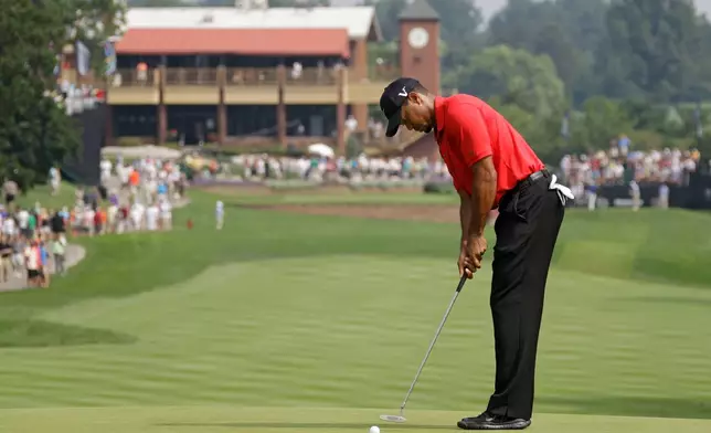 FILE - Tiger Woods taps in his par putt on the first hole during the final round of the Bridgestone Invitational golf tournament at Firestone Country Club in Akron, Ohio, Aug. 7, 2011. (AP Photo/Mark Duncan, File)