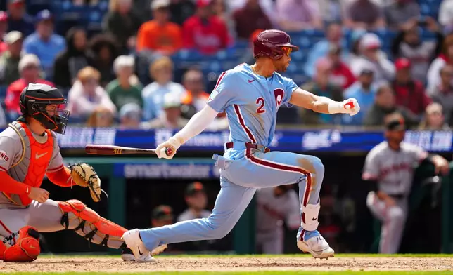 Philadelphia Phillies' Justin Crawford hits a walk off RBI single to drive in the game-winning run in the ninth inning of the first baseball game of a doubleheader against the San Francisco Giants, Thursday, April 30, 2026, in Philadelphia. (AP Photo/Derik Hamilton)