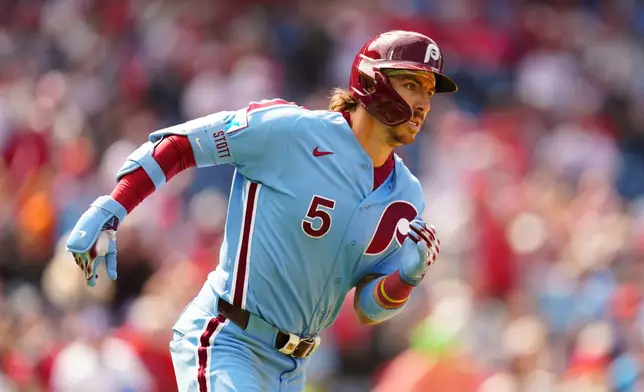 Philadelphia Phillies' Bryson Stott runs after hitting an RBI triple off San Francisco Giants pitcher Ryan Walker during the ninth inning of the first baseball game of a doubleheader, Thursday, April 30, 2026, in Philadelphia. (AP Photo/Derik Hamilton)