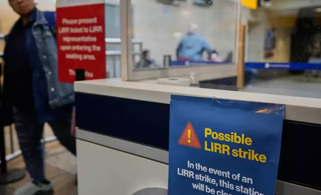 A sign warns commuters of a potential Long Island Rail Road strike at Penn Station in New York, Thursday, May 14, 2026. (AP Photo/Seth Wenig)