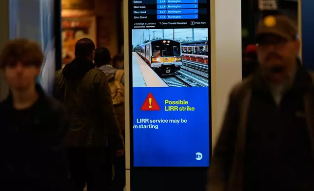 A sign warns commuters of a potential Long Island Rail Road strike at Penn Station in New York, Thursday, May 14, 2026. (AP Photo/Seth Wenig)