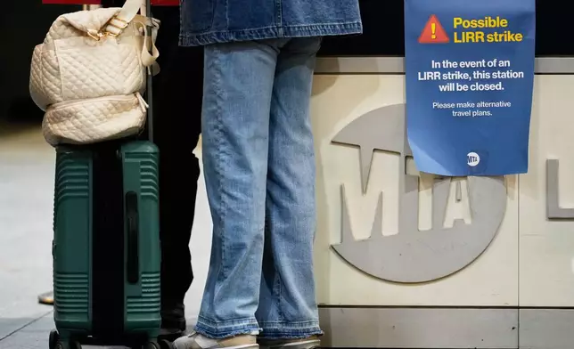 A sign warns commuters of a potential Long Island Rail Road strike at Penn Station in New York, Thursday, May 14, 2026. (AP Photo/Seth Wenig)