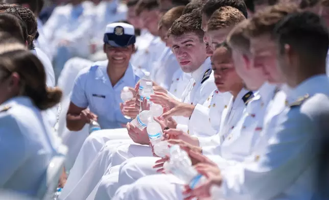 U.S. Coast Guard Academy Cadets endure the heat as President Donald Trump speaks during the commencement address at the U.S. Coast Guard Academy, in New London, Conn., Wednesday, May 20, 2026. (AP Photo/Jacquelyn Martin)