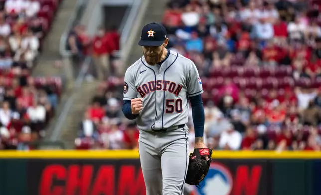Houston Astros pitcher Mike Burrows reacts after preventing a run in the fourth inning of a baseball game against the Cincinnati Reds, Friday, May 8, 2026, in Cincinnati. (AP Photo/Michael Swensen)