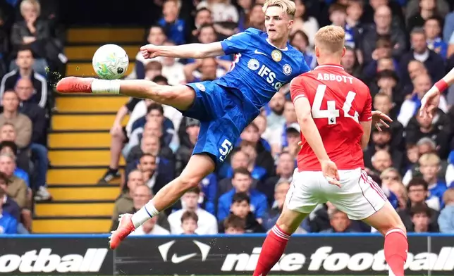 Chelsea's Jesse Derry, left, attempts a shot towards goal during the English Premier League soccer match between Chelsea and Nottingham Forest in London, Monday, May 4, 2026. (John Walton/PA via AP)