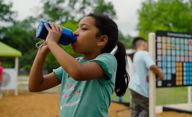 Second-grader Alexis Enriquez drinks Elkay-filtered water on the playground at Dalton Elementary School in Uvalde, TX.