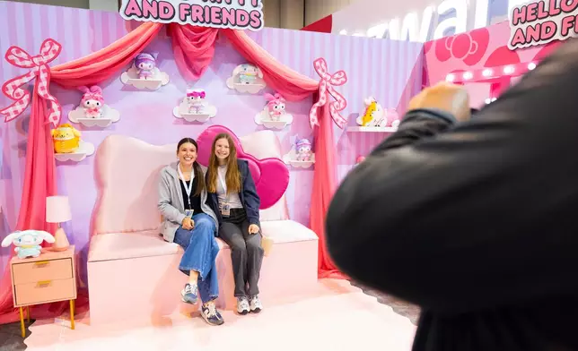Shareholder Anna Larsen, 16, left, of Underwood, Iowa, poses for photo with her friend Ainsley Roberts, 17, in the Hello Kitty portion of the Squishmallows display in the Berkshire Hathaway annual meeting on Saturday, May 2, 2026, in Omaha, Neb. (AP Photo/Rebecca S. Gratz)