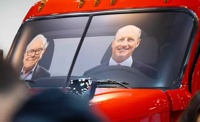 Portraits of Berkshire Hathaway's Warren Buffett, left, and CEO Greg Abel sit in a semi truck at the Pilot display in the Berkshire Hathaway annual meeting on Saturday, May 2, 2026, in Omaha, Neb. (AP Photo/Rebecca S. Gratz)