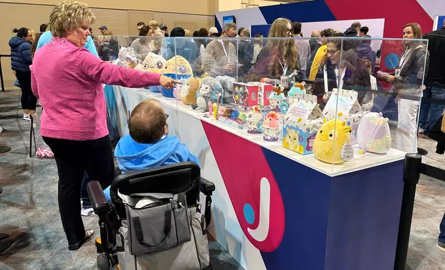 Berkshire Hathaway shareholders stand in line to purchase Squishmallows versions of the company's top executives: CEO Greg Abel, Chairman Warren Buffett and former Vice Chairman Charlie Munger on Friday, May 1, 2026 in Omaha, Neb. (AP Photo/Josh Funk)