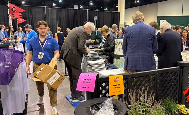 Author and former Omaha World-Herald reporter Steve Jordan signs copies of his book at the Berkshire Hathaway shareholders event on Friday, May 1, 2026 in Omaha, Neb. (AP Photo/Josh Funk)