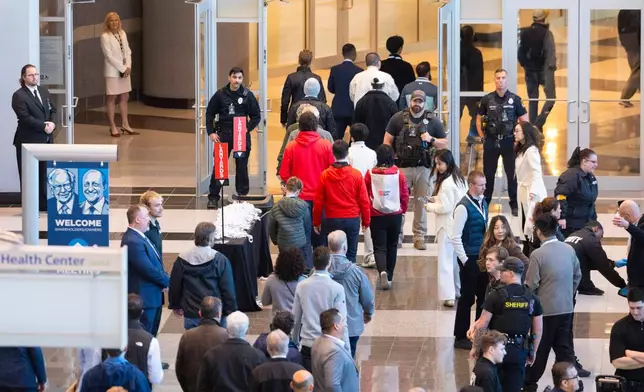 Shareholders enter the CHI Health Center Omaha for the Berkshire Hathaway annual meeting on Saturday, May 2, 2026, in Omaha, Neb. (AP Photo/Rebecca S. Gratz)