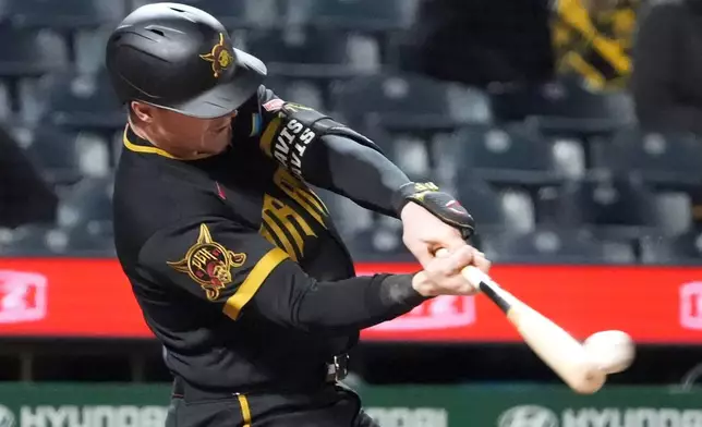 Pittsburgh Pirates catcher Henry Davis connects with a pitch from Cincinnati Reds pitcher Zach Maxwell for a two run home run in the fifth inning of a baseball game in Pittsburgh, Friday, May 1, 2026. (AP Photo/Tom E. Puskar)