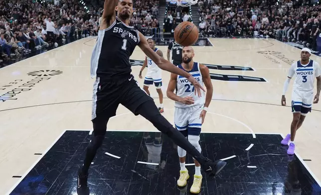San Antonio Spurs forward Victor Wembanyama (1) scores against the Minnesota Timberwolves during the first half of Game 5 of an NBA basketball second-round playoffs series in Minneapolis, Tuesday, May 12, 2026. (AP Photo/Eric Gay)