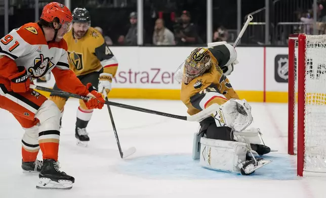 Anaheim Ducks center Leo Carlsson (91) attempts to shoot past Vegas Golden Knights goaltender Carter Hart (79) during the first period of Game 1 of a second-round NHL hockey Stanley Cup playoff series Monday, May 4, 2026, in Las Vegas. (AP Photo/John Locher)