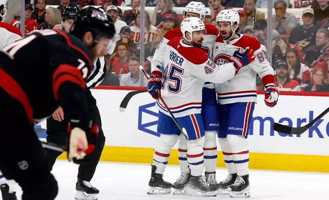 Montréal Canadiens celebrate their third goal during the first period in Game 1 of the Eastern Conference finals NHL hockey Stanley Cup playoffs series against the Carolina Hurricanes in Raleigh, N.C., Thursday, May 21, 2026. (AP Photo/Karl DeBlaker)