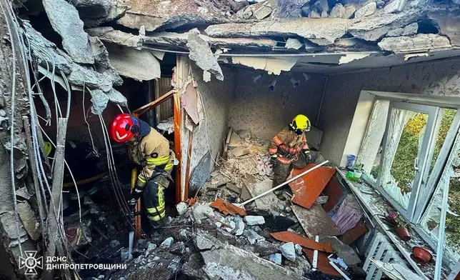 In this photo provided by the Ukrainian Emergency Service, firefighters put out a fire in a building following a Russian air attack in Dnipropetrovsk region, Ukraine, Thursday, May 21, 2026. (Ukrainian Emergency Service via AP)