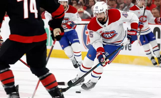 Montréal Canadiens' Alexandre Carrier (45) controls the puck against the Carolina Hurricanes during the first period in Game 1 of the Eastern Conference finals NHL hockey Stanley Cup playoffs series in Raleigh, N.C., Thursday, May 21, 2026. (AP Photo/Karl DeBlaker)