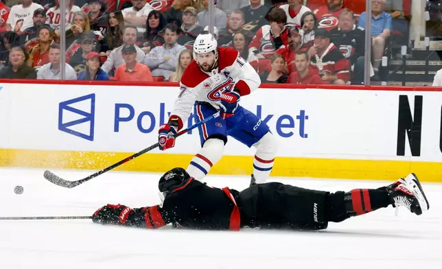 Carolina Hurricanes' K'andre Miller (19) slides to the ice to attempt to block a pass by Montréal Canadiens' Josh Anderson (17) during the first period in Game 1 of the Eastern Conference finals NHL hockey Stanley Cup playoffs series in Raleigh, N.C., Thursday, May 21, 2026. (AP Photo/Karl DeBlaker)