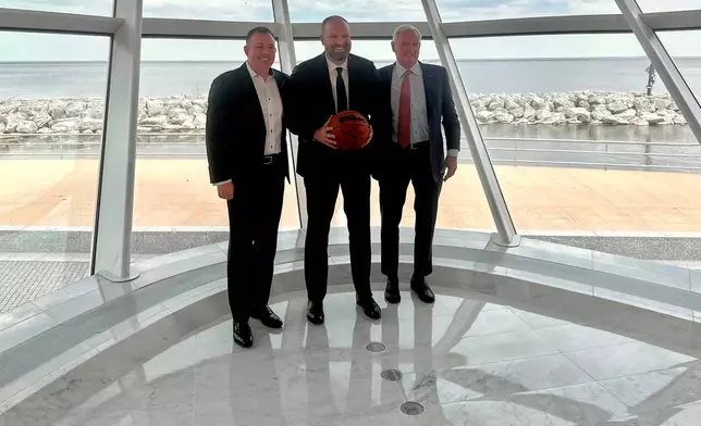 Milwaukee Bucks' new head coach Taylor Jenkins, center, poses with general manager Jon Horst, left, and co-owner Jimmy Haslam after an NBA basketball news conference, Wednesday, May 6, 2026, at the Milwaukee Art Museum in Milwaukee. (AP Photo/Steve Megargee)