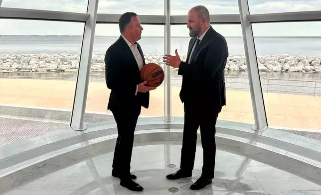 Milwaukee Bucks' new head coach Taylor Jenkins, right, speaks with speaks with general manager Jon Horst after an NBA basketball news conference, Wednesday, May 6, 2026, at the Milwaukee Art Museum in Milwaukee. (AP Photo/Steve Megargee)