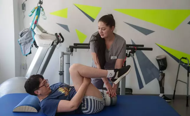 Physical therapist Anastasiia Stetsenko stretches Iryna Nakonechna during exercises at a rehab center in Kryvyi Rih, Ukraine, Friday, May 8, 2026. (AP Photo/Evgeniy Maloletka)