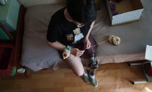 Iryna Nakonechna knits a toy capybara at her home in Kryvyi Rih, Ukraine, Friday, May 8, 2026. (AP Photo/Evgeniy Maloletka)